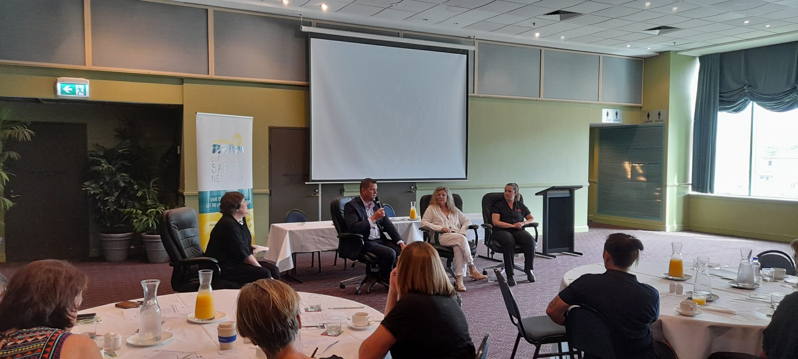 The Q&A Panel are seated at the front of the event. From left to right are Olivia Jamieson (Organisational Culture Specialist), Simon Joice (Mid North Coast Local Health District), Rowena Bianchino (The Harbour Therapy Clinic), Larissa Davidson (Hoys Health).